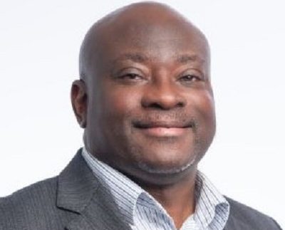 a black man in a grey suit and light blue shirt