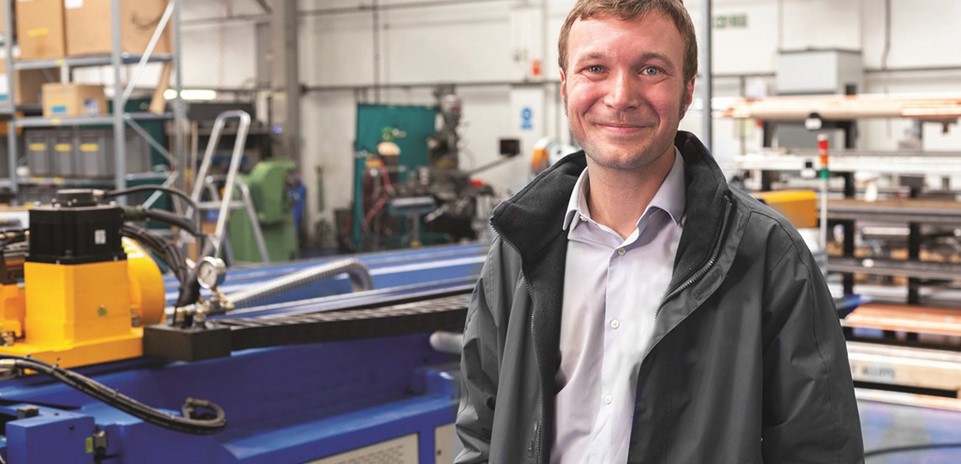 a smiling man in a work shop