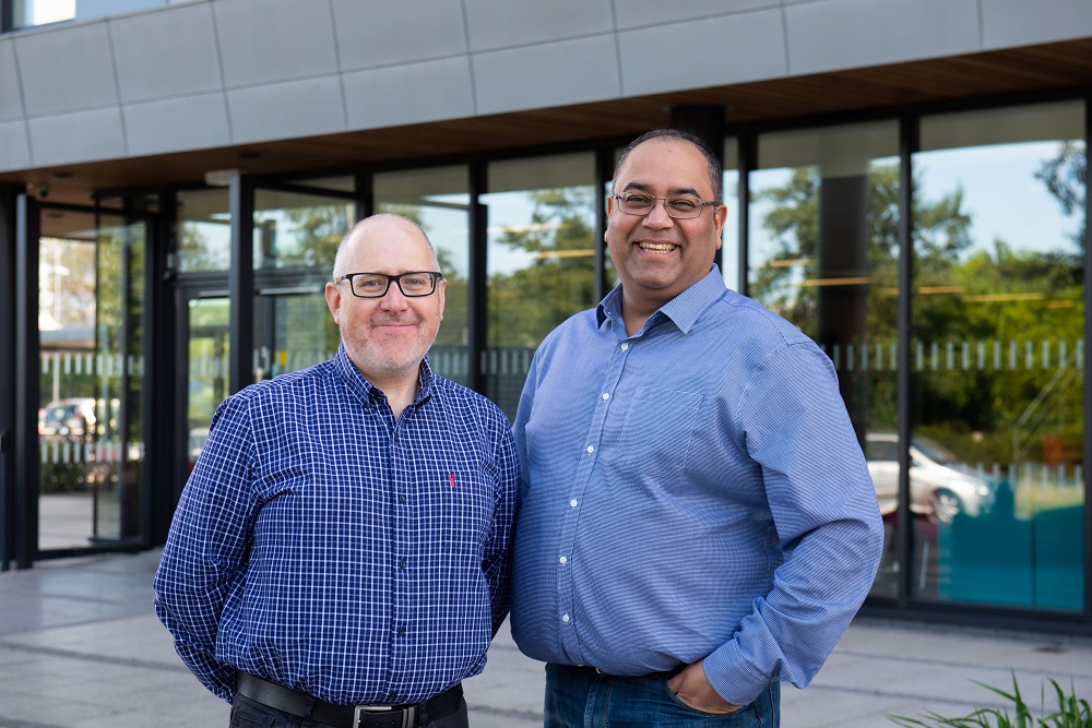 Two men in blue shirts