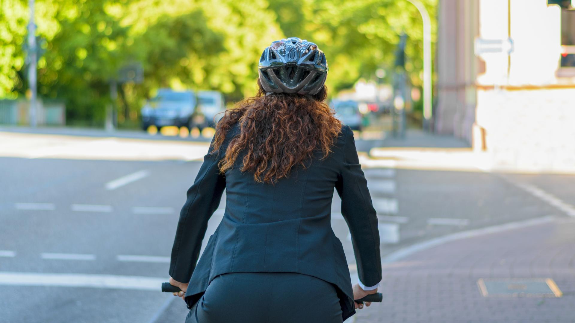 back of female in suit on bike