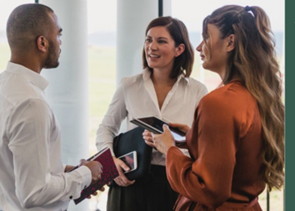 Two women and a man networking
