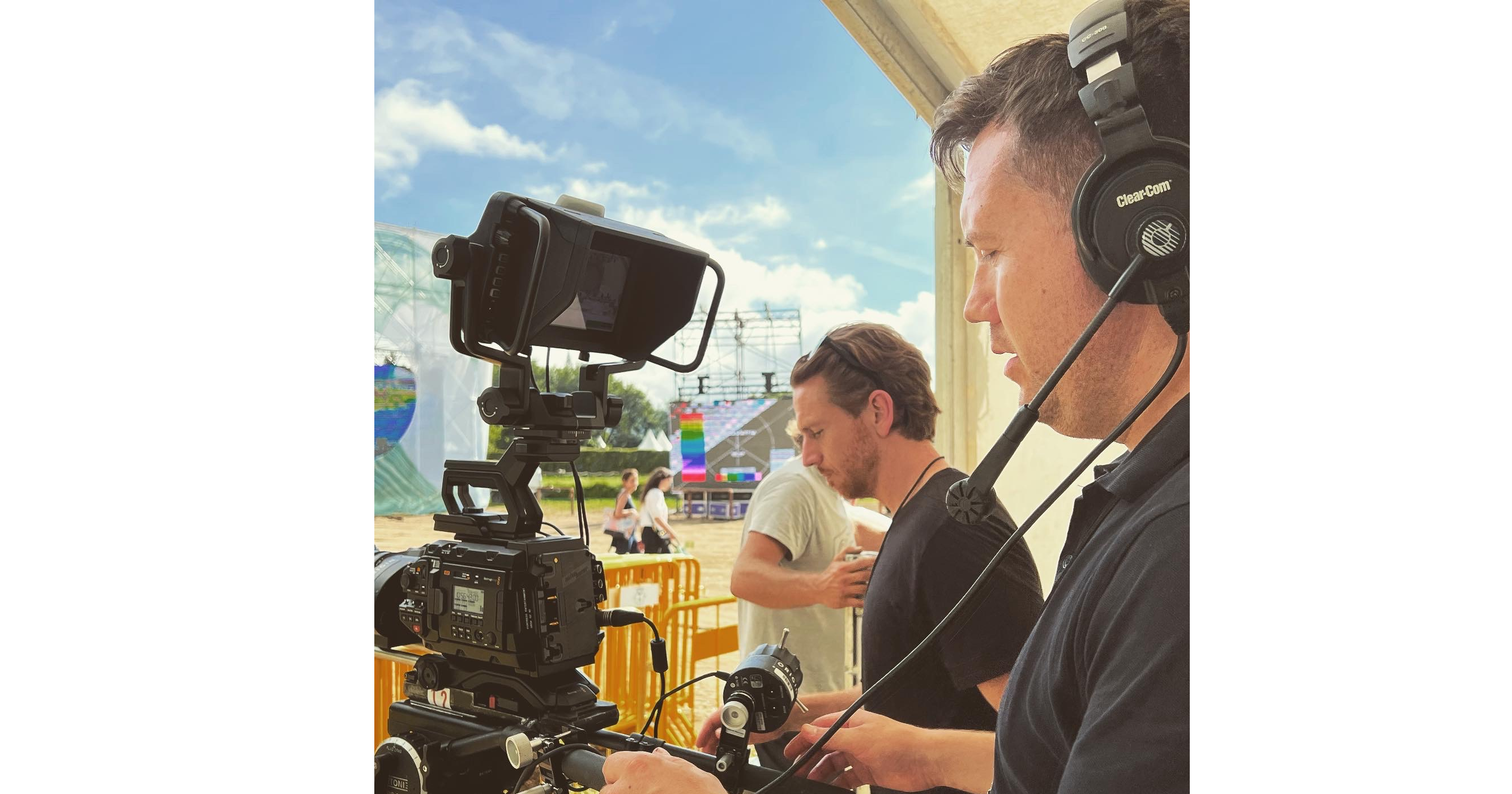 man filming with camera and headphones on