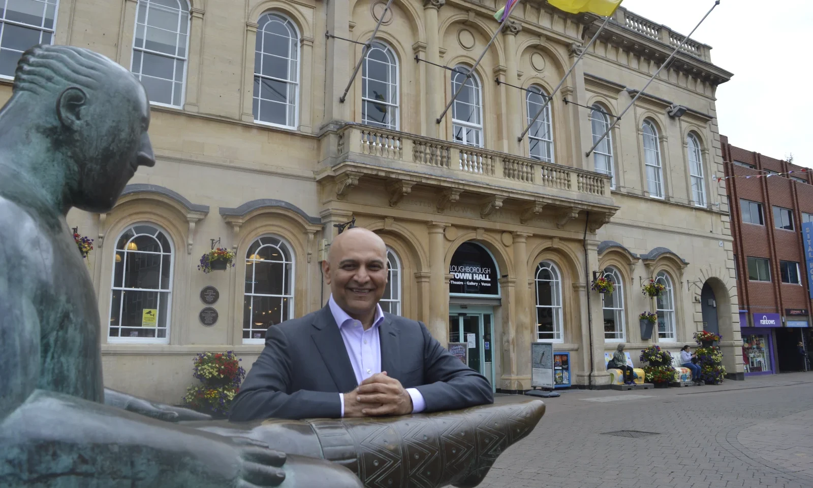 man by fountain smiling
