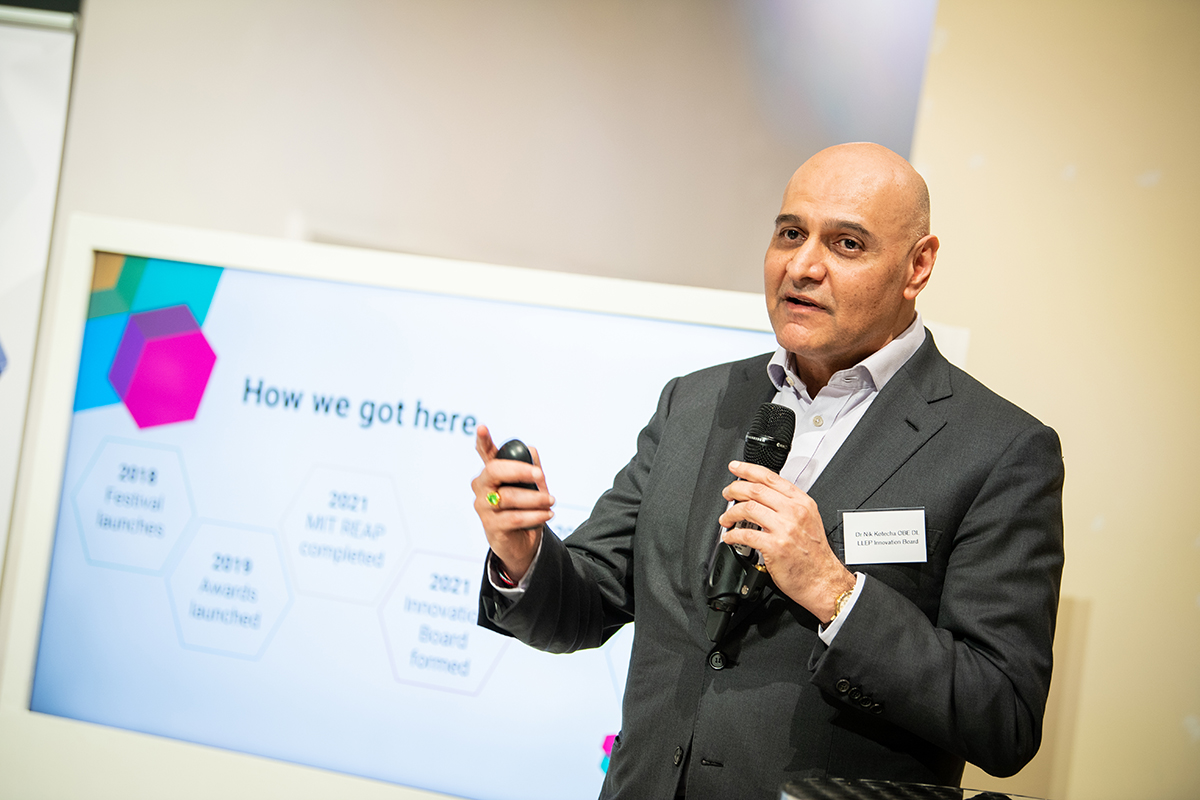 man in suit, holding a mic