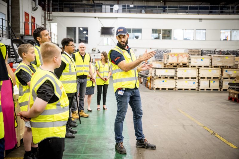 Business Benefits showing young people in a logistics warehouse
